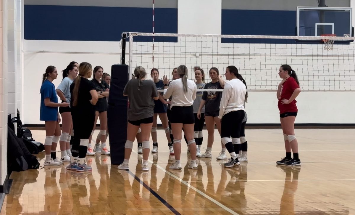 The women's club volleyball team meets ahead of a scrimmage Jan. 29, 2024.