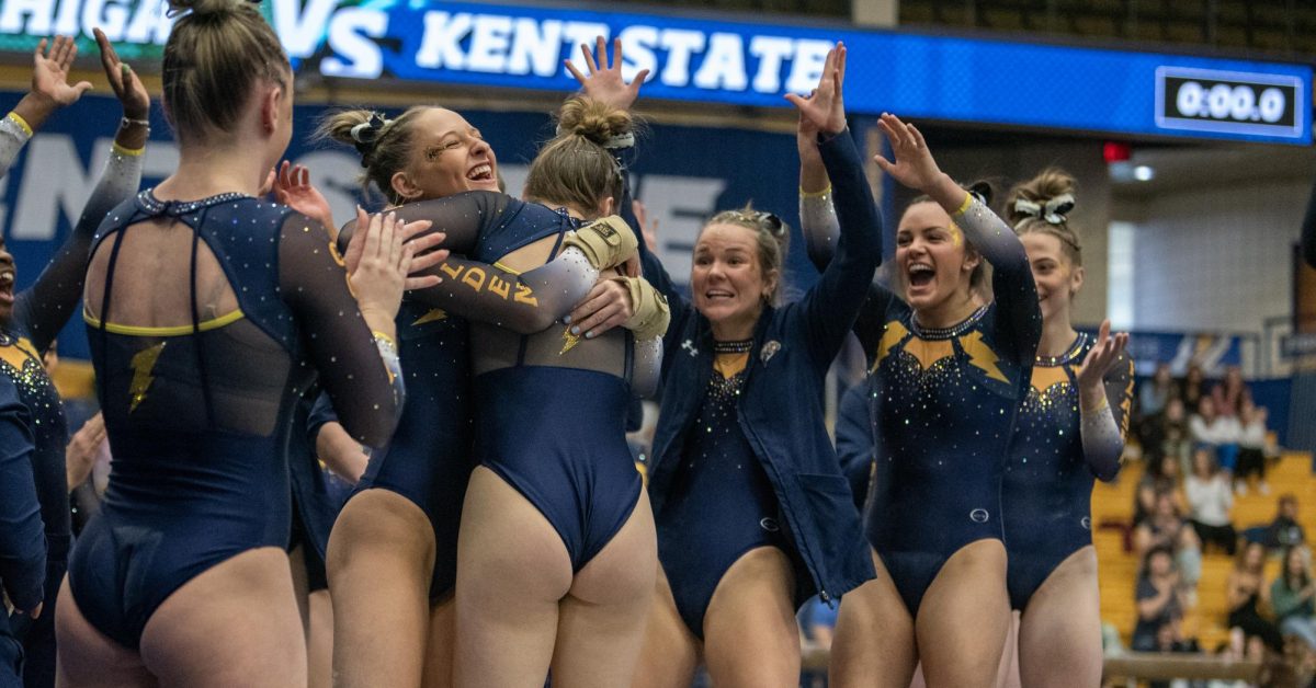 The gymnastics team celebrates at a meet during the 2024 season.