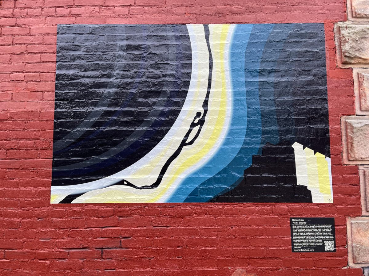 The 'River Eclipse', a work by Danny Likar is on display on the side of Grazers in Downtown Kent on March 20, 2024. The work is meant to depict a view of the Cuyahoga River from above during the eclipse. 