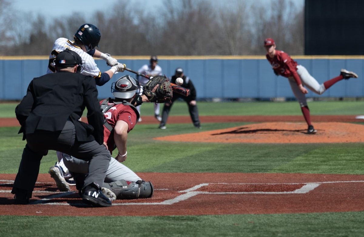 With Jake Casey sitting at third, Kent State's Brody Williams swings under St. Joseph's Ryan DeSanto's pitch during their game March 24, 2024. Williams went 0-1 with two walks in three plate appearances against the Hawks.