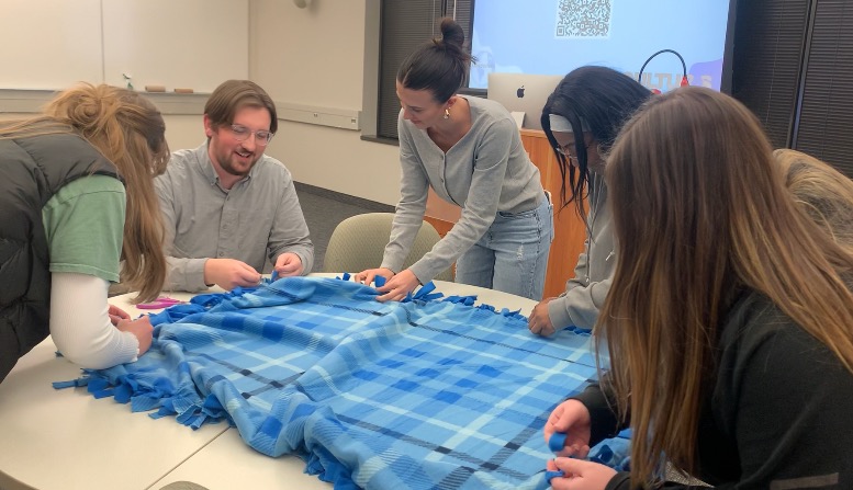 Members of the Bateman Blue team working on a blanket.