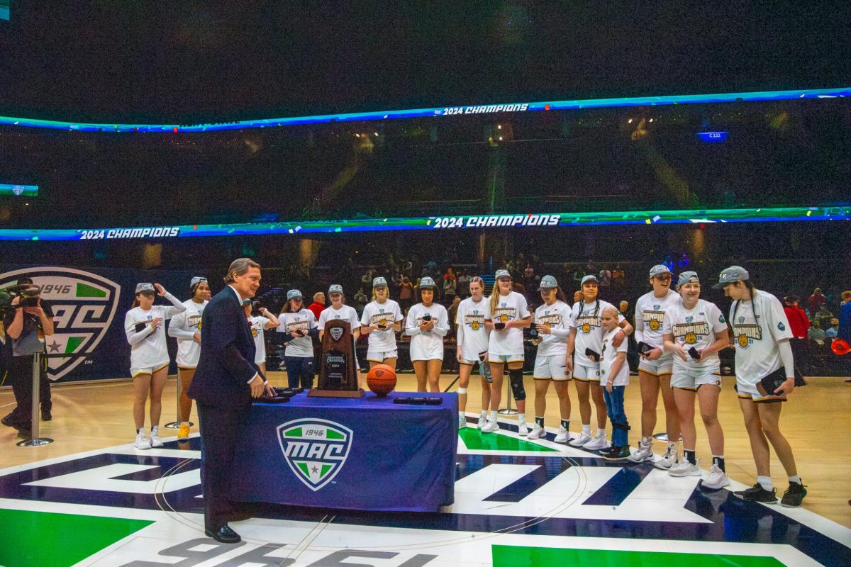 The Kent State women's basketball team line up to receive their trophy for winning the MAC Women's Basketball tournament on Saturday, March 16, 2024. 