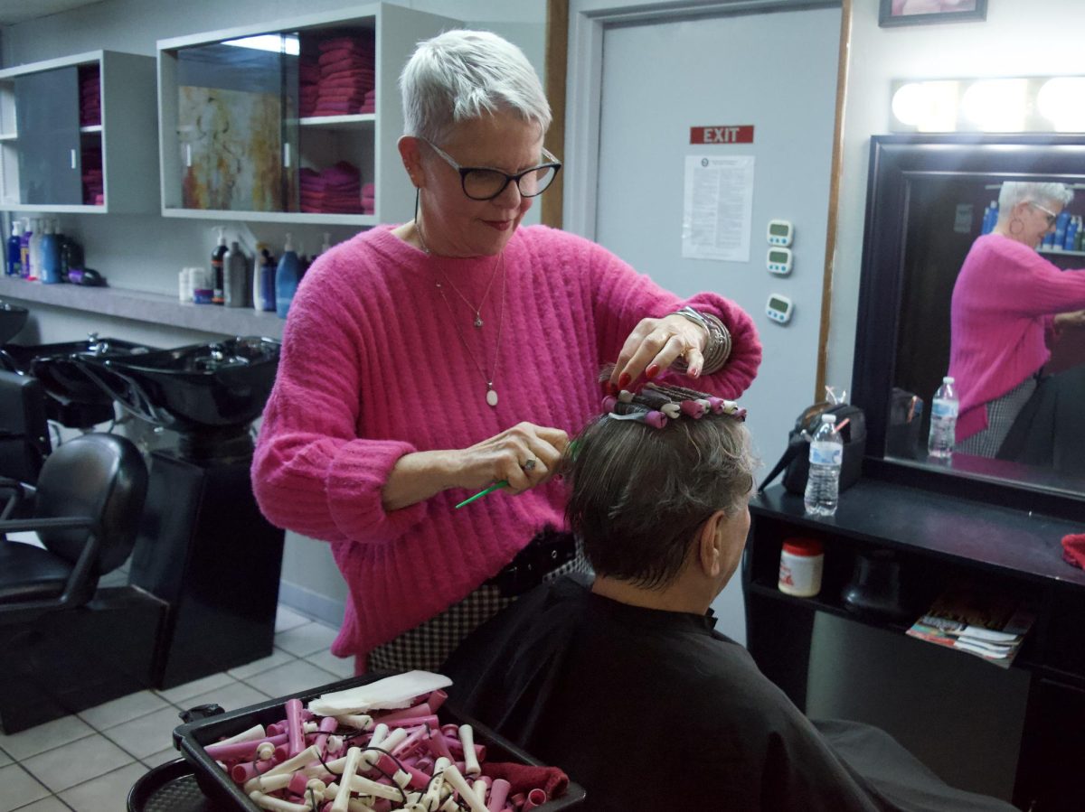 Laura Marlow does a perm for a client at A Cut Above Hair and Nail Salon on March 20, 2024.