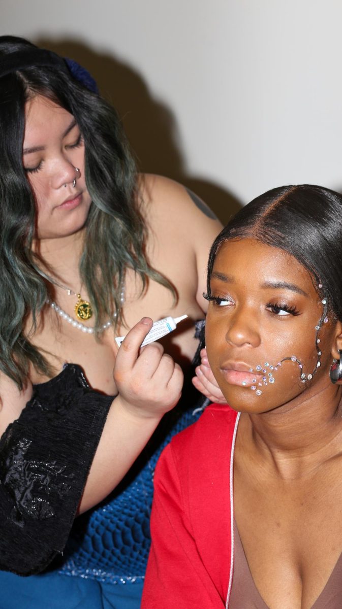 Candace Drew has her make-up done by her designer, Katherine McClure, for the Fabric Pantry's annual fashion show on March 9, 2024.