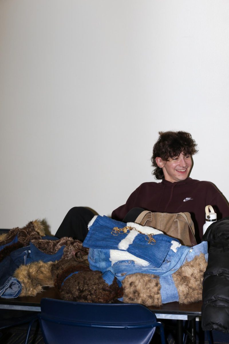 Alex Bayus relaxes before as he prepares to put on his garment for the Fabric Pantry's annual fashion show on March 9, 2024. 