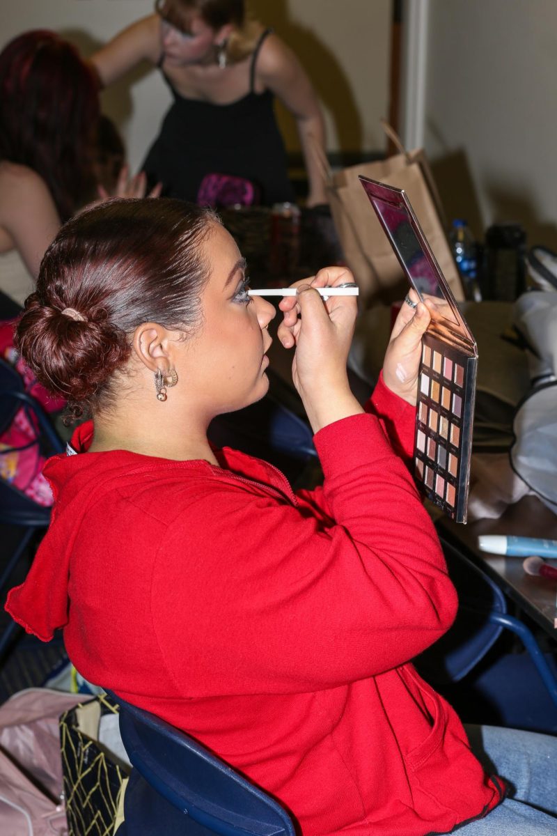 Devin does her own makeup for the Fabric Pantry annual fashion show on  on March 9, 2024.