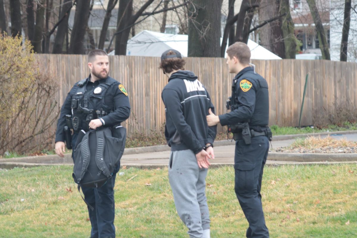 A man getting arrested outside a Dunkin Donuts on March 9, 2024 Fake Paddy's Day.