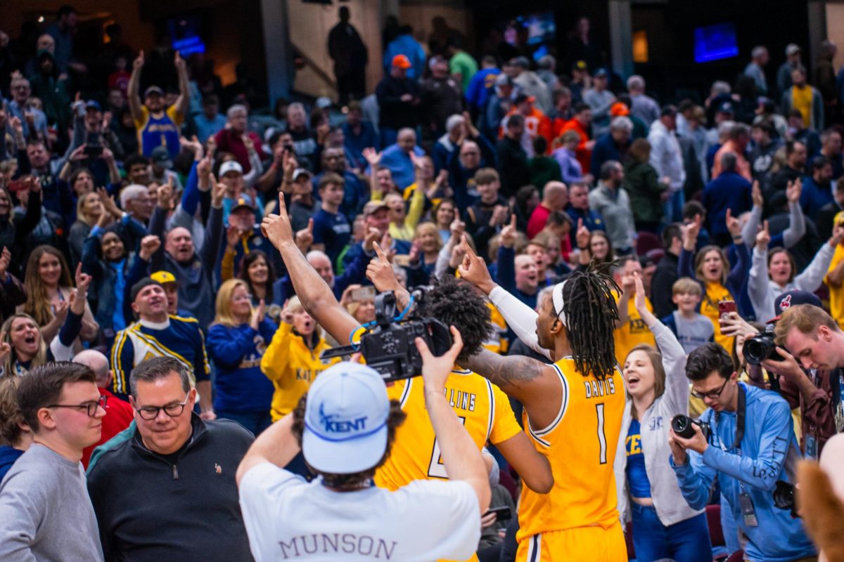 The Kent State men's basketball team celebrates their win with the cheering crowd on March 15, 2024.