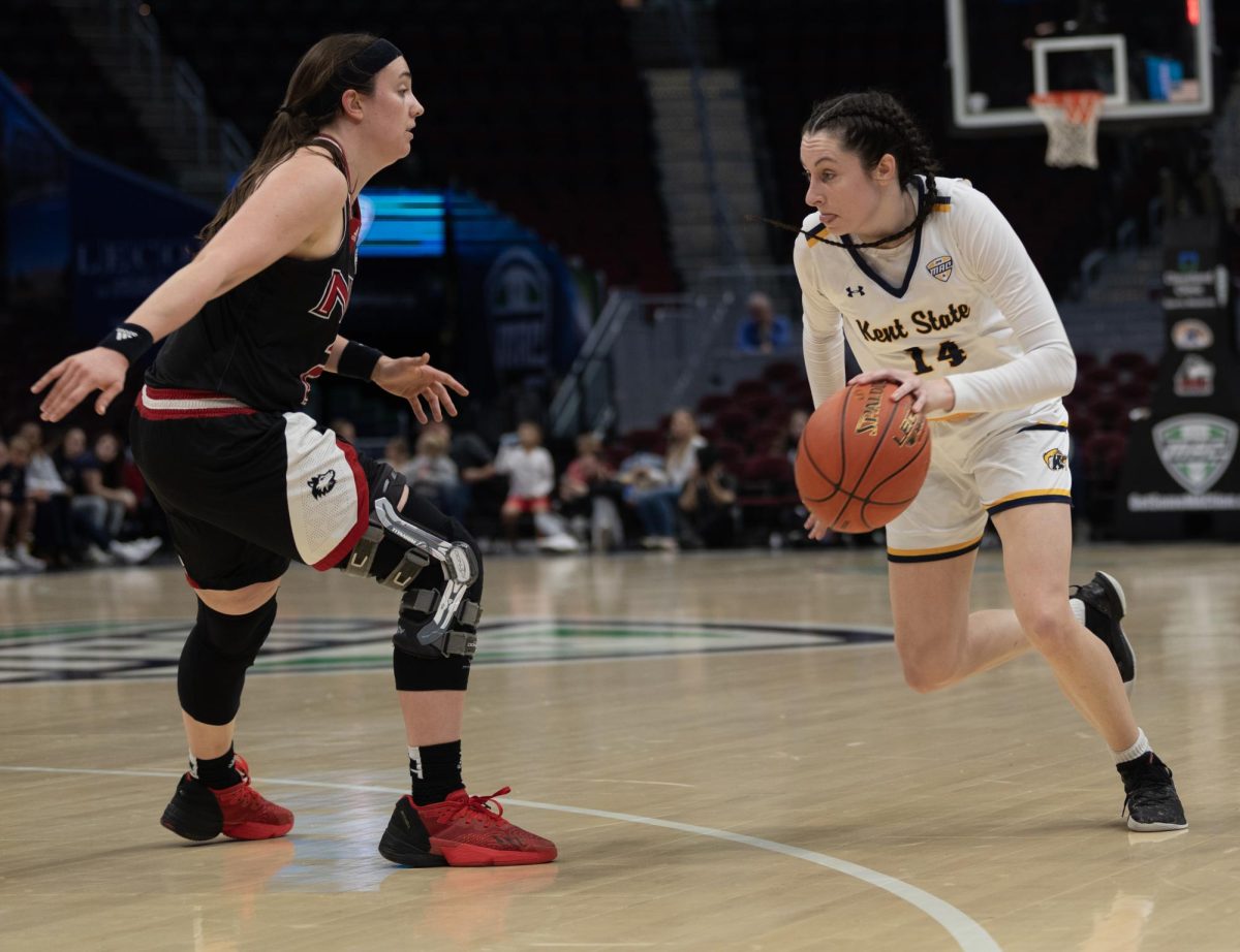 Redshirt Senior Guard Katie Shumate starts to drive past Northern Illinois' Sidney McCrea during their Mid-American Conference Quarterfinal game on March 13, 2024.