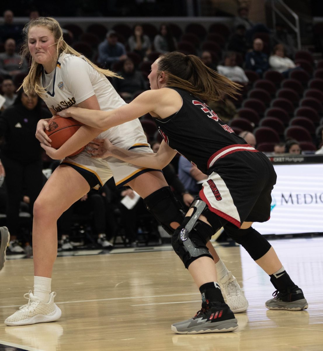 Graduate Student Center Mikala Morris pulls the ball away during a tie-up from Northern Illinois' Laura Nickel during their Mid-American Conference Quarterfinal game on March 13, 2024.