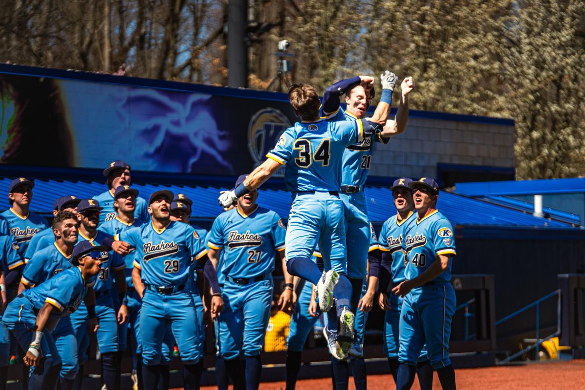 Hunter Klotz celebrates his play with his team in the dugout on April 7, 2024.