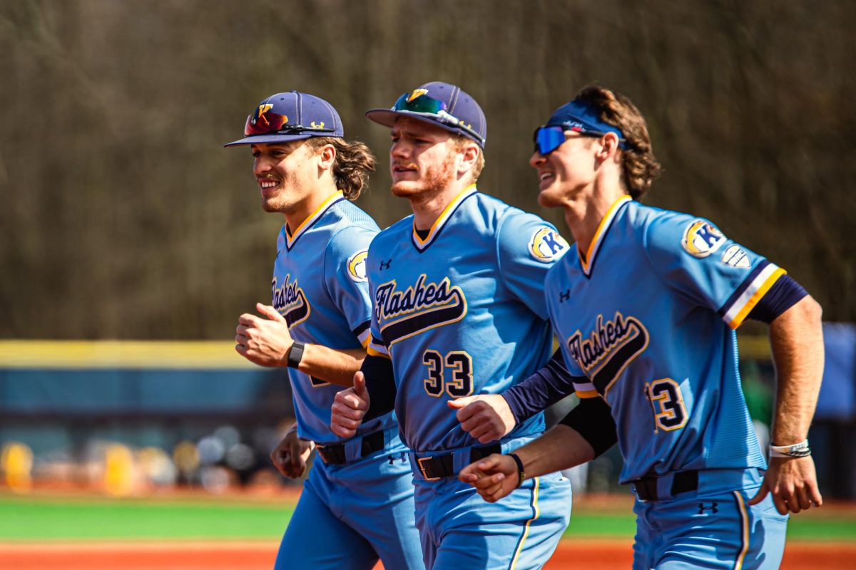 Junior Aiden Hinds (left), Senior Tim Orr (middle) and Junior Connor Ashby (right) rush toward their team huddle after their win against East Michigan with a score of 9-2 on April 7, 2024.