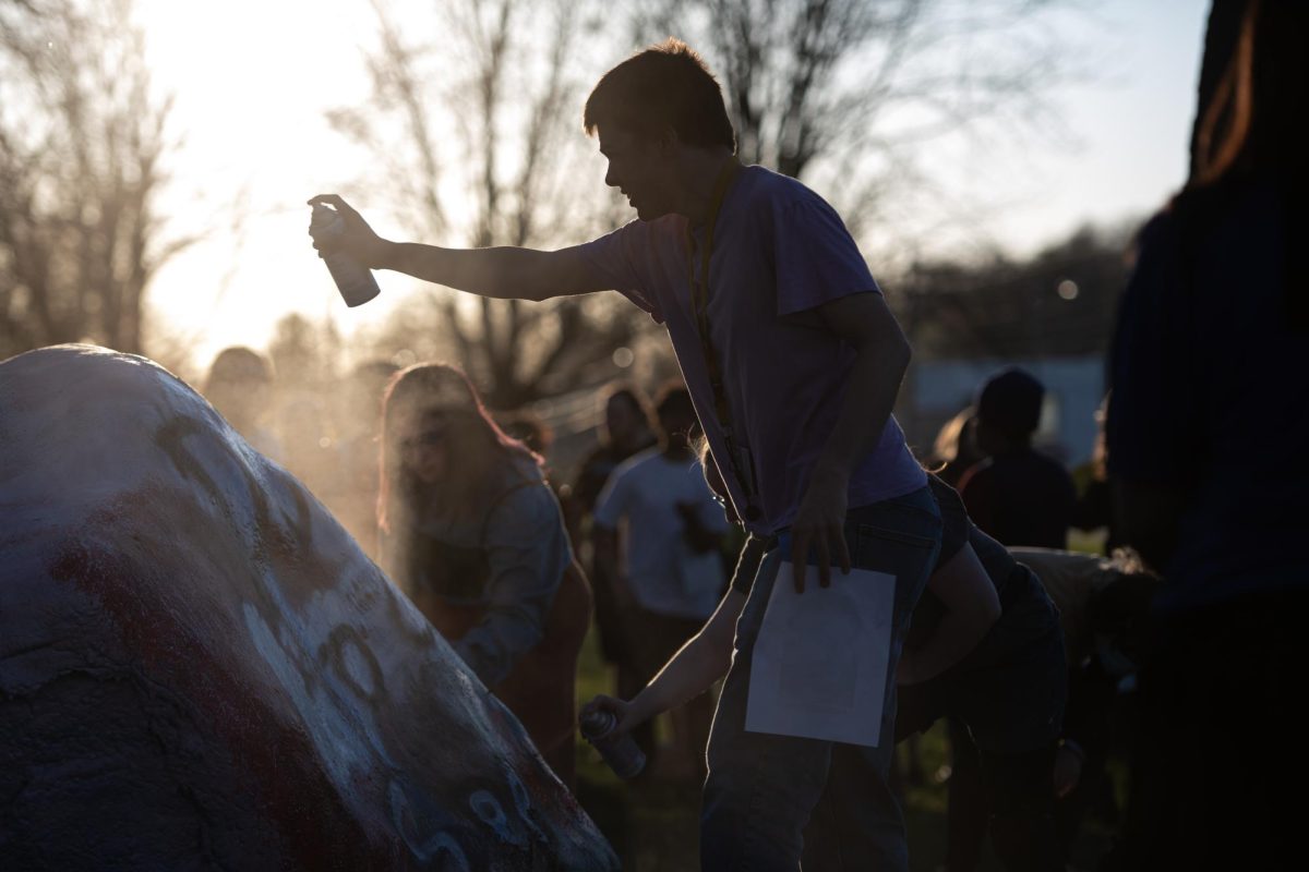 Participants of the protest speaking out against Kyle Rittenhouse's campus visit paint the Rock April 15, 2024.