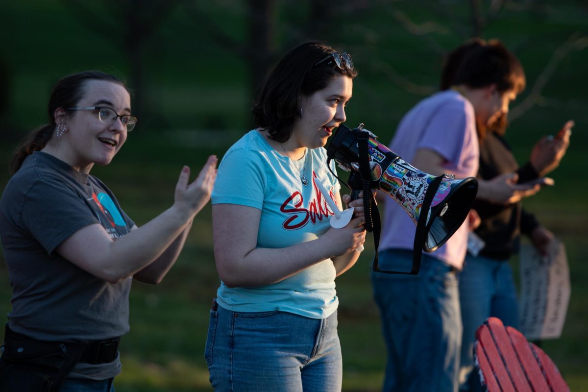 Junior anthropology major Nica-Emmanuel Delgado speaks at the Rock before the lighting of the candles for a candlelight vigil during the protest April 15, 2024.