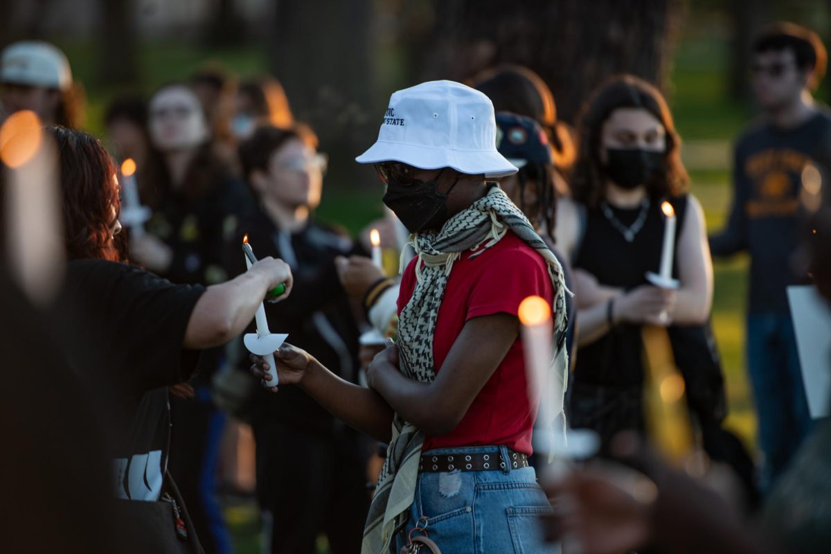 With lit candles in hand, participants of the protest against Kyle Rittenhouse's campus visit hold a candlelight vigil for those who've lost their lives to acts of injustice April 15, 2024.