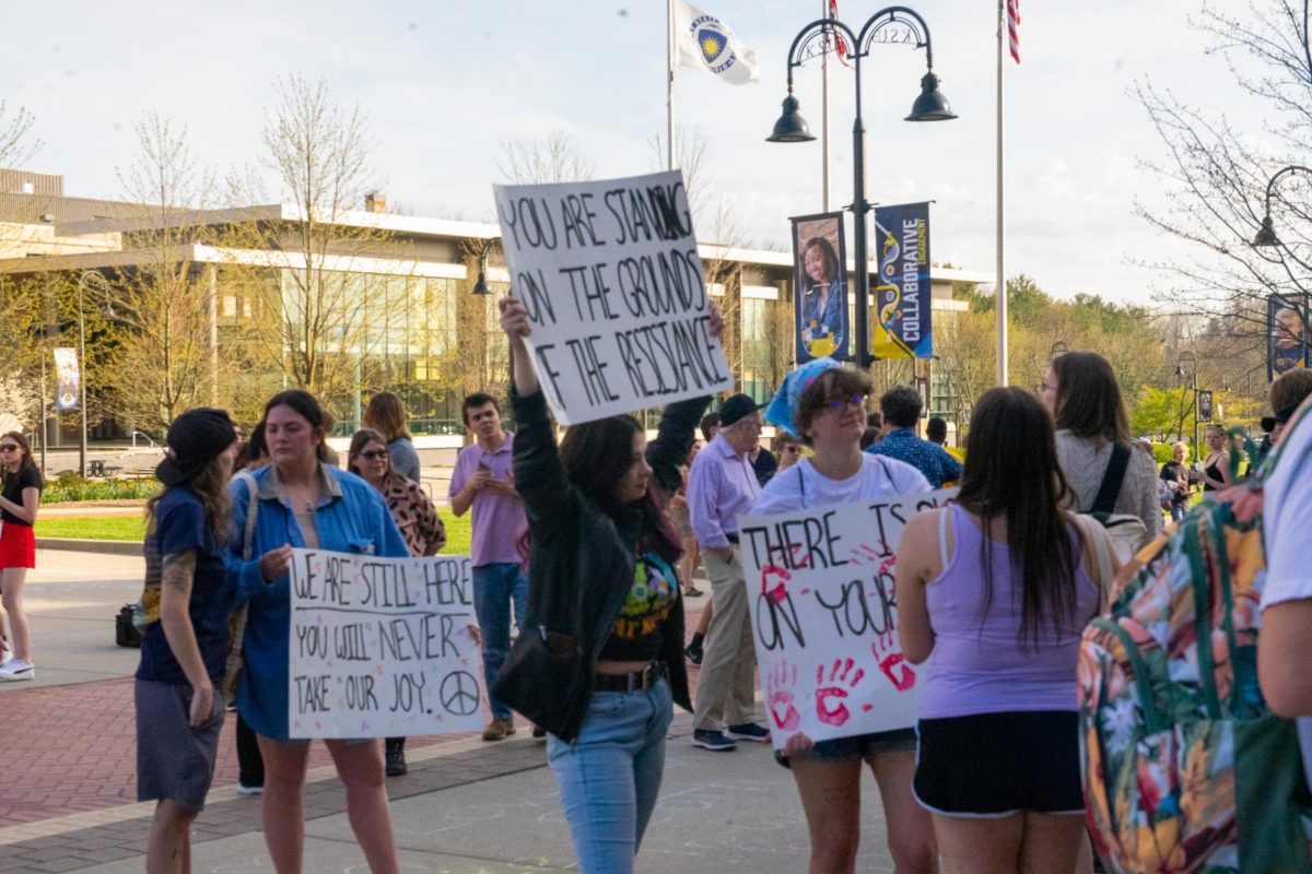 Protestors hold up their signs outside of the KIVA during The Rittenhouse Recap April 16, 2024.