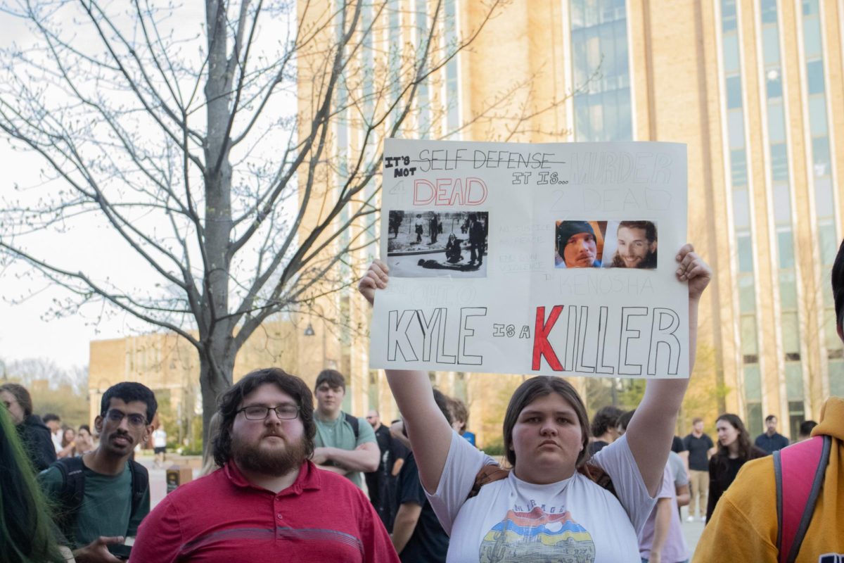 Two people protest Kyle Rittenhouse's visit to Kent State's campus April 16, 2024.