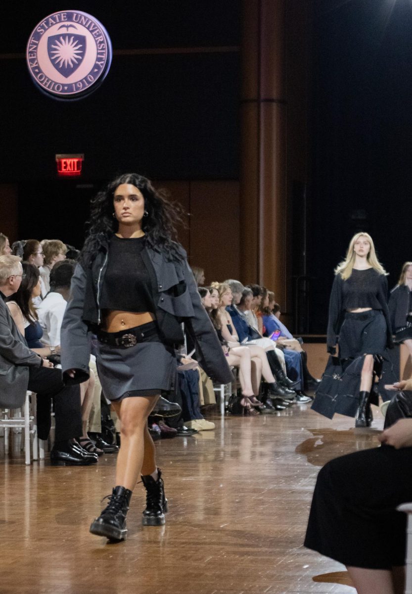 A pair of models walk down the runway during the fashion show on April 25, 2024.