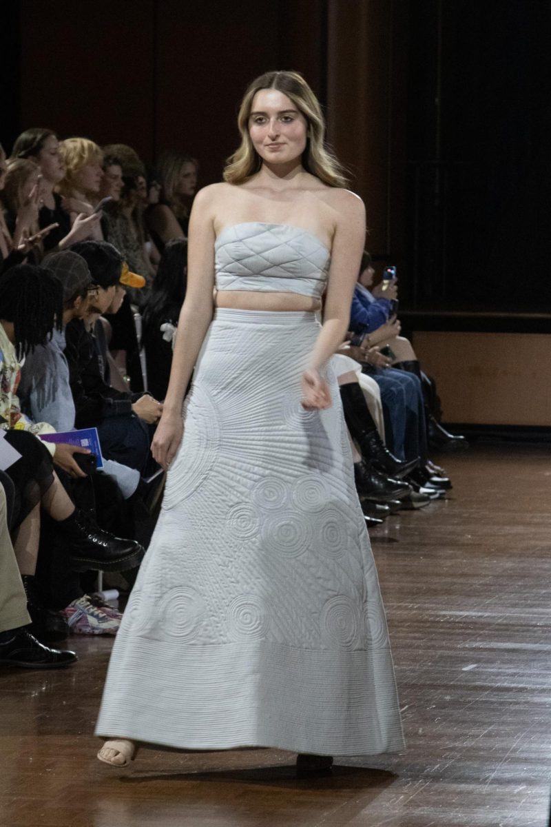 A model poses in the center of the runway on April 25, 2024.