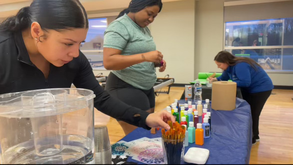 Students practicing mindfulness through painting and yoga March 20, 2024.