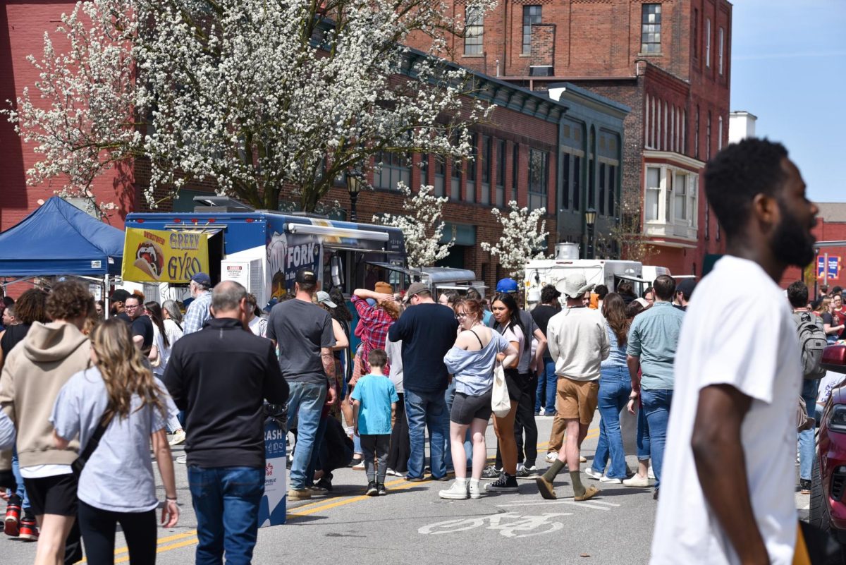 People gather in downtown Kent to view the solar eclipse on April 8, 2024.