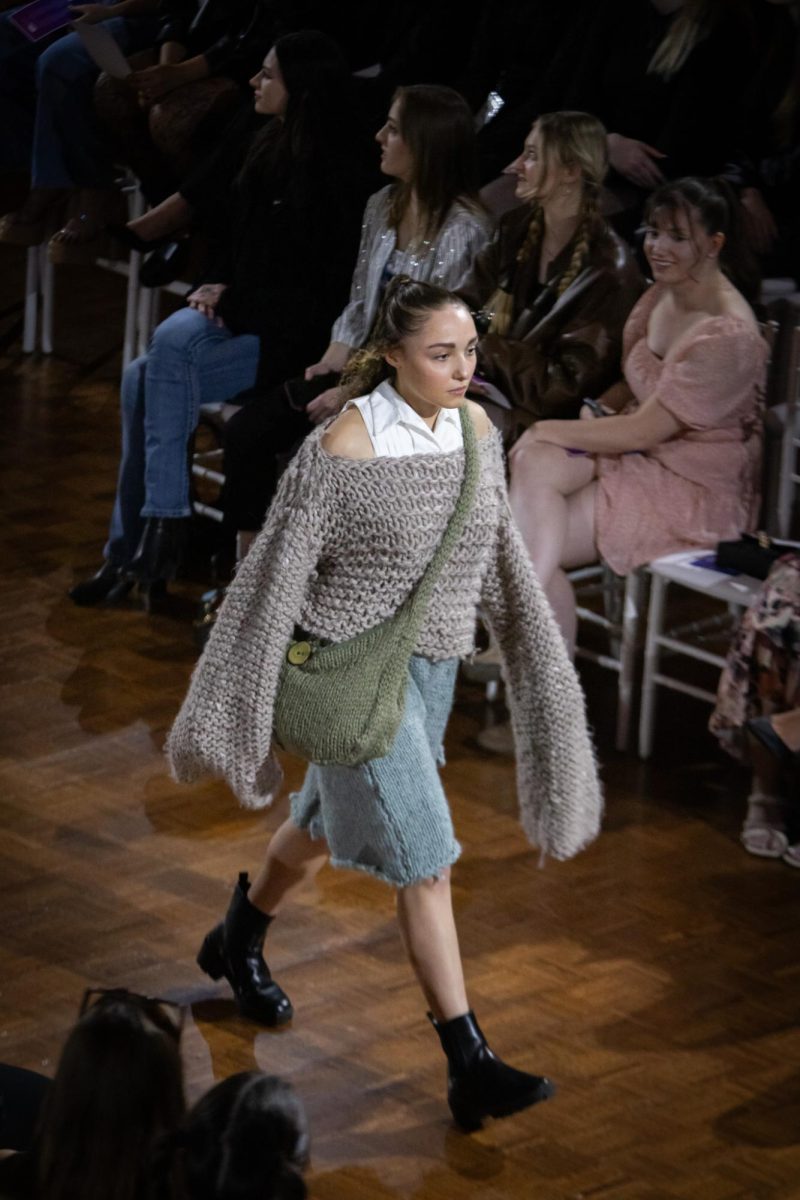 Model walks down aisle wearing a garment designed by a fashion student during the KSU Annual Fashion Show on April 25, 2024.