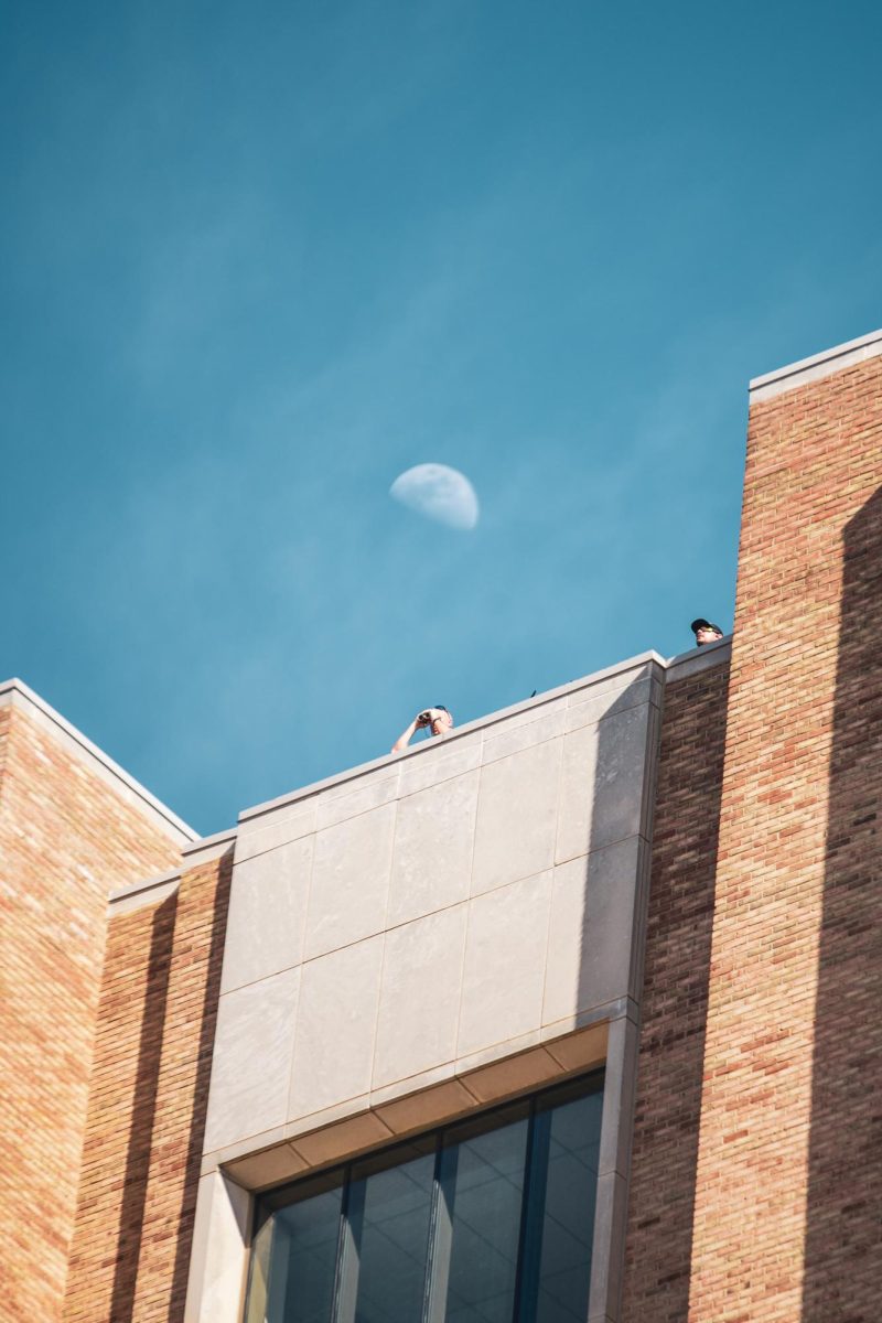 Law enforcement observes from the roof of the library as a crowd forms near the KIVA April 16, 2024.