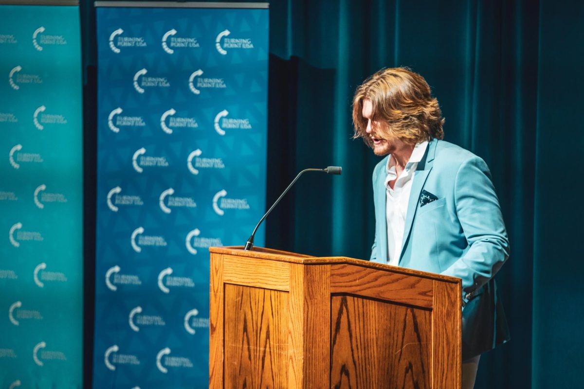 Brady Seymour, president of the university's chapter of Turning Point USA, welcomes the crowd in anticipation of Kyle Rittenhouse's arrival April 16, 2024.