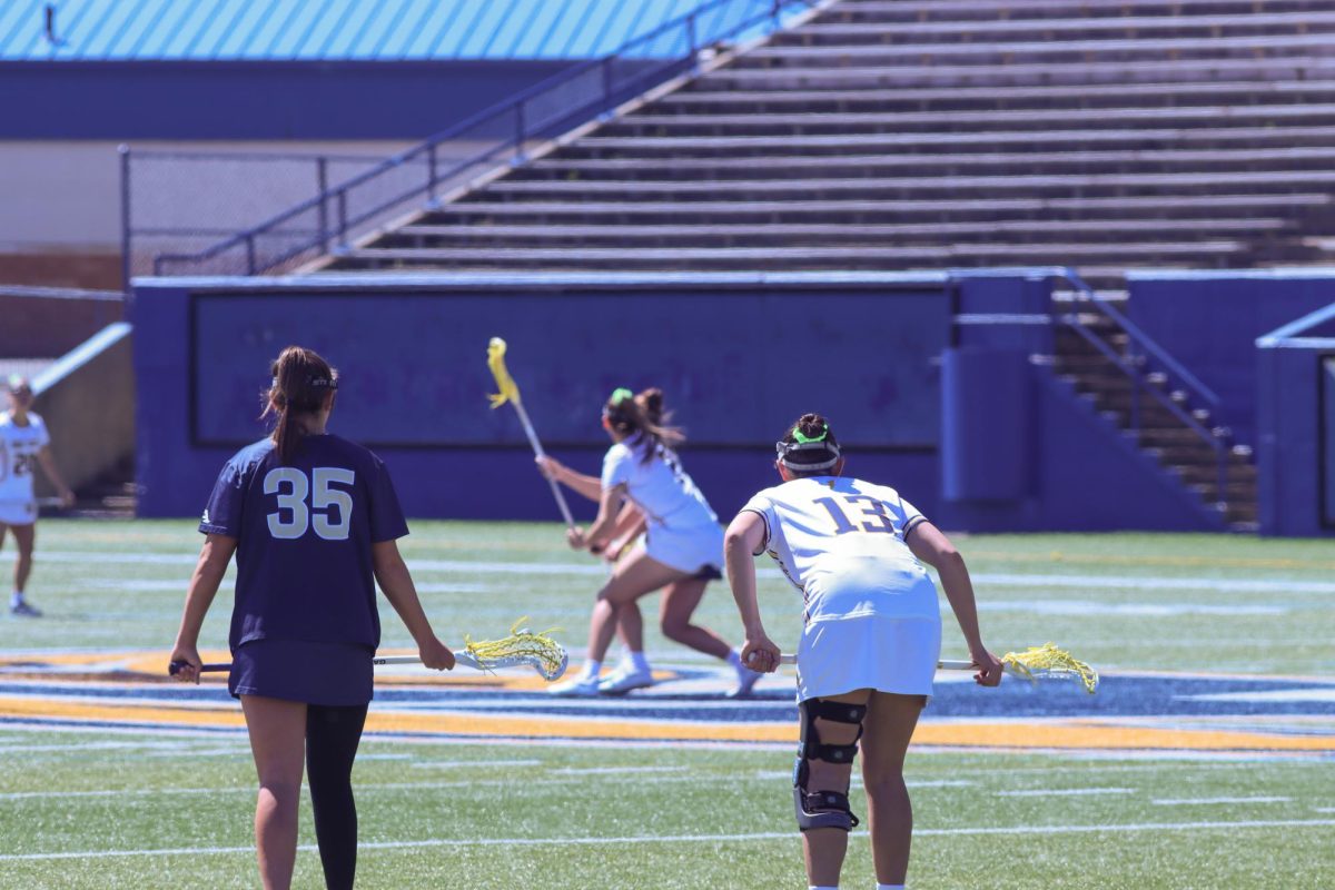 Grad Student Delaney Knipp watches on as her teammate faces off against the University of Akron on April 7, 2024.