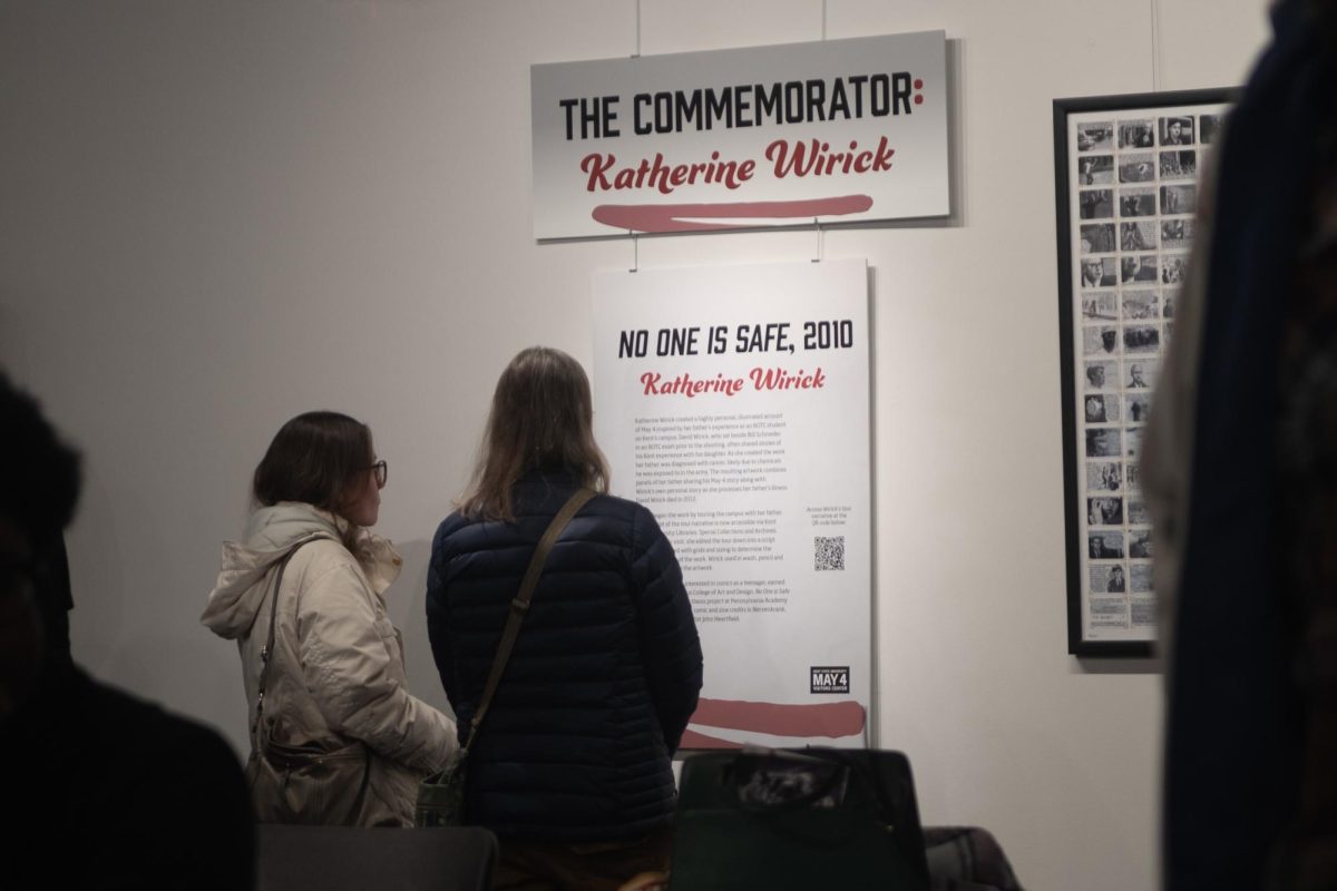 People peruse the "Graphic Content" exhibit in the Reflections Gallery of the May 4th Visitors Center.