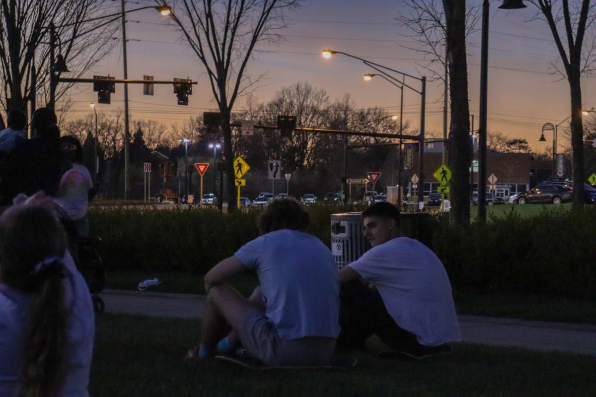 Friends sit together to watch totality during the solar eclipse April 8, 2024. 