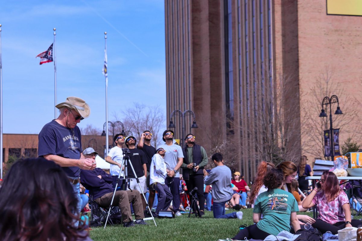 Students gather with their glasses on to watch as the moon covered the sun during the solar eclipse on April 8, 2024.