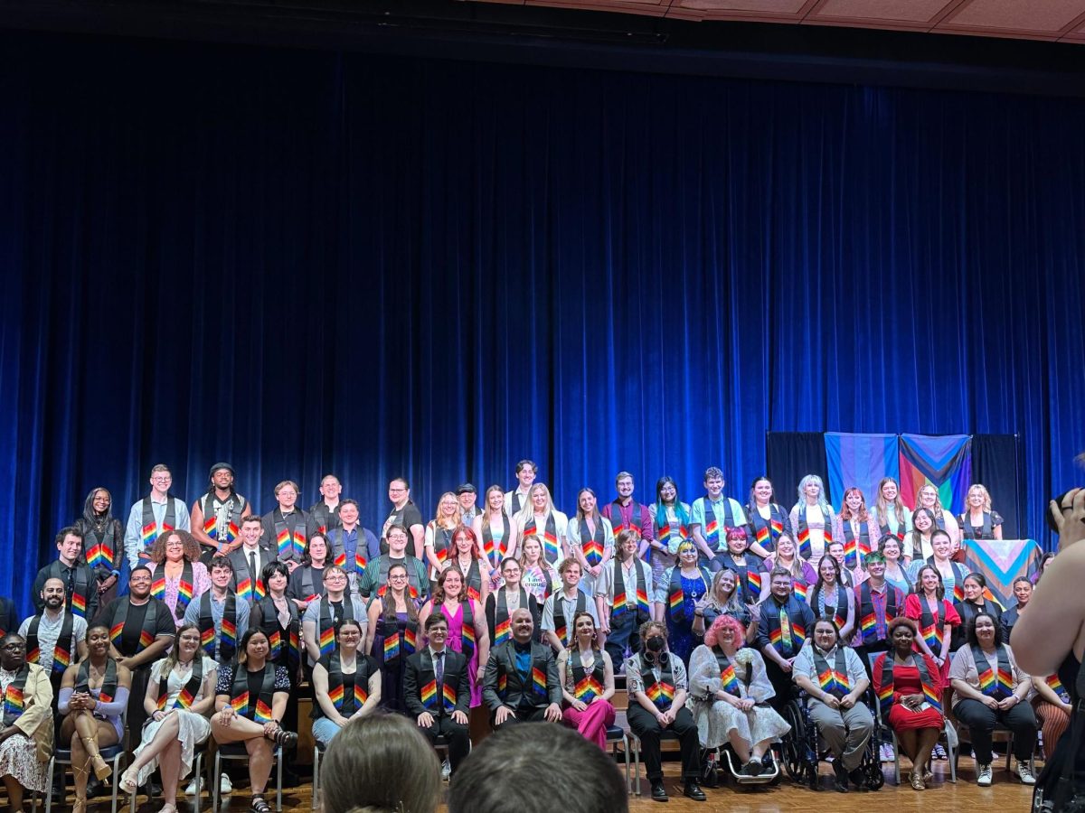 Graduates pose on stage Thursday at the Kent Student Center Ballroom for Lavender Graduation, an annual event honoring the accomplishments of LGBTQ+ graduates.