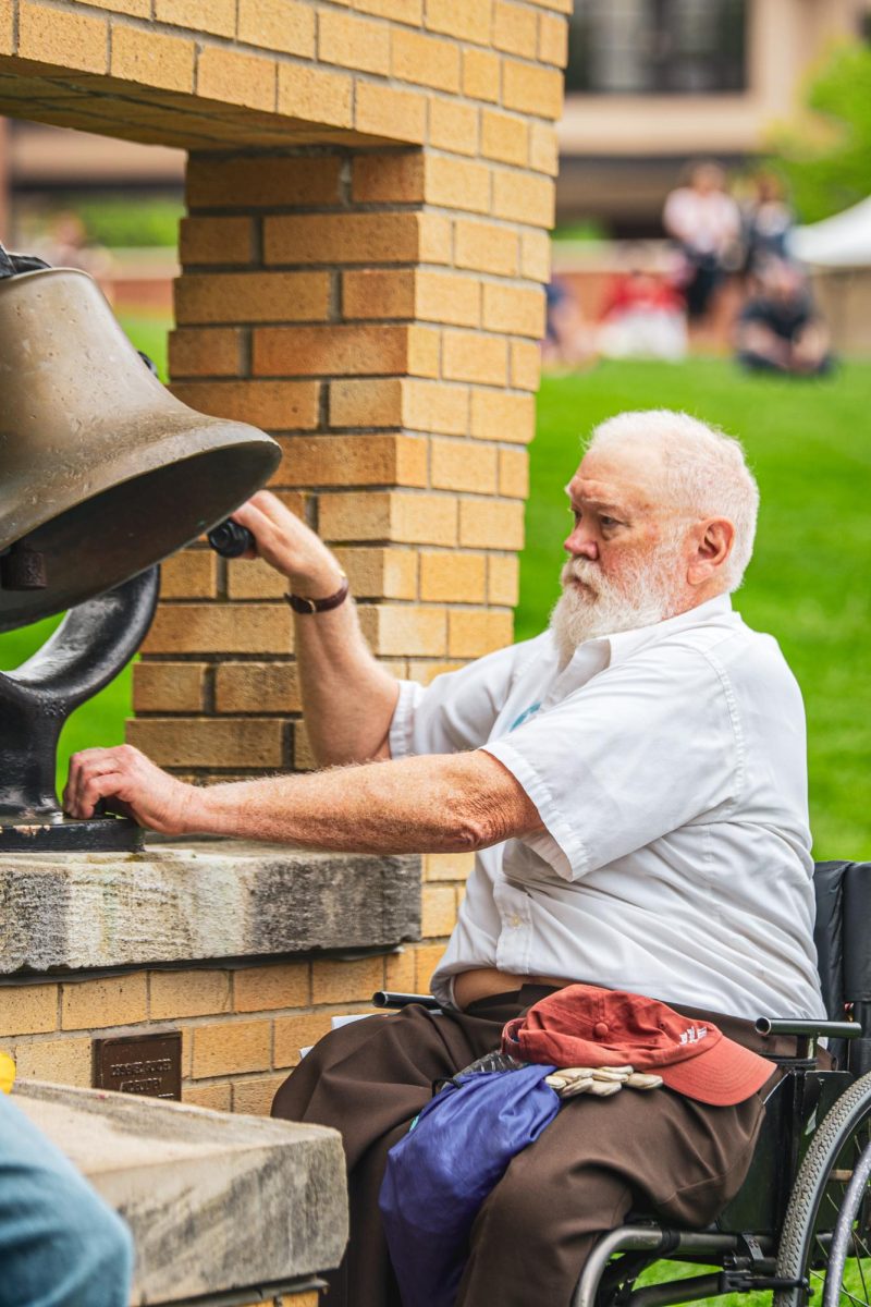 May 4 survivor Dean Kahler rings the bell during the commemoration on May 4, 2024.