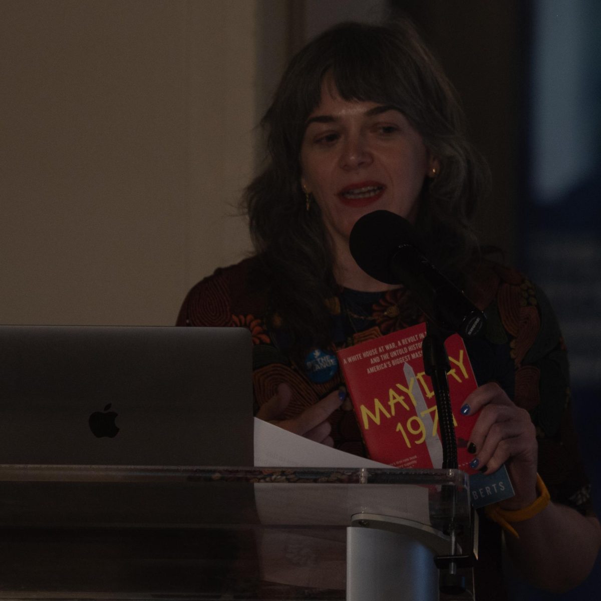 May 4th Visitor Center Director Alison Caplan introduces Lawrence Roberts' book "Mayday 1971" prior to Roberts' presentation on Voices of Democracy on May 3, 2024.