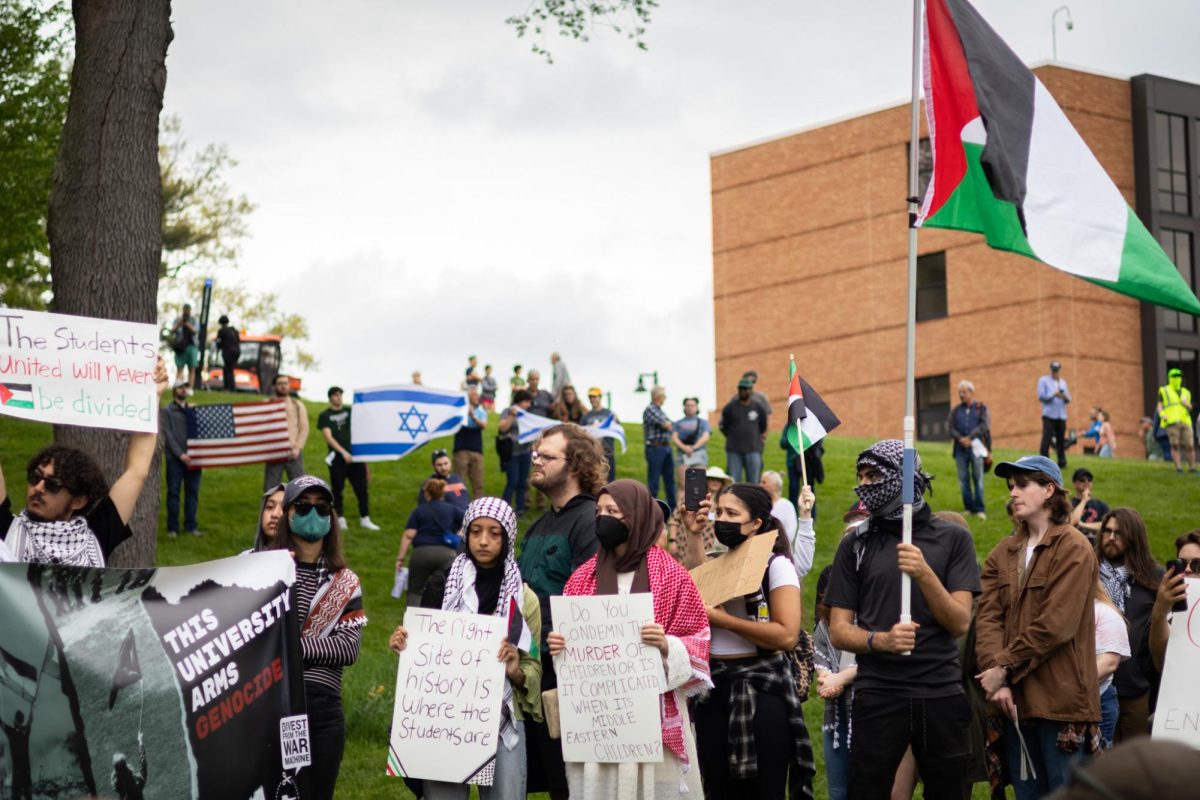 A protest for Palestine occurs at Taylor Field, and in the background people holding an American flag and Israeli flags, brought by Alex Casparis can be seen on May 4, 2024. 