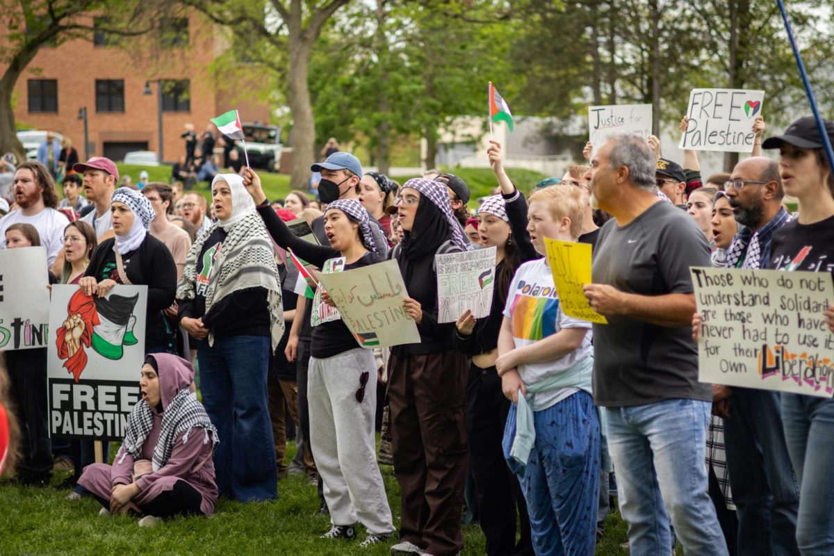 A crowd of people hold up signs and flags in support of Palestine on May 4, 2024.