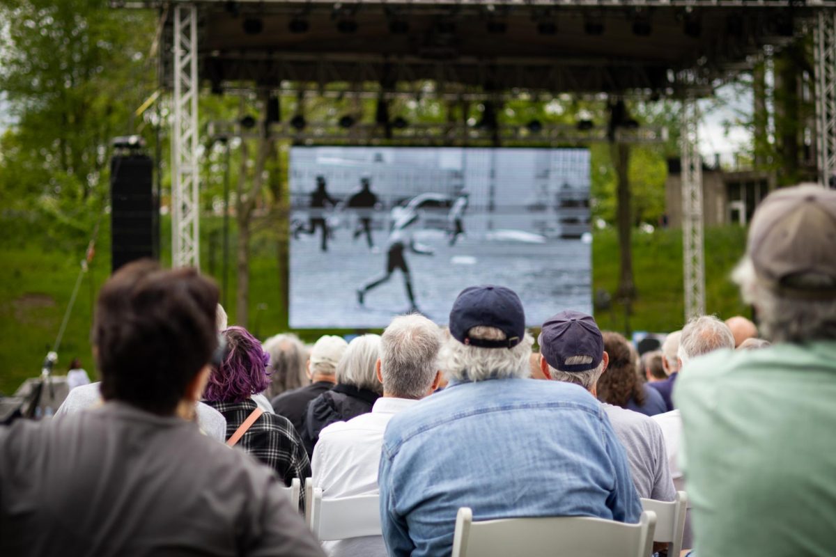 People watch a video during the May 4th commemoration on May 4, 2024.