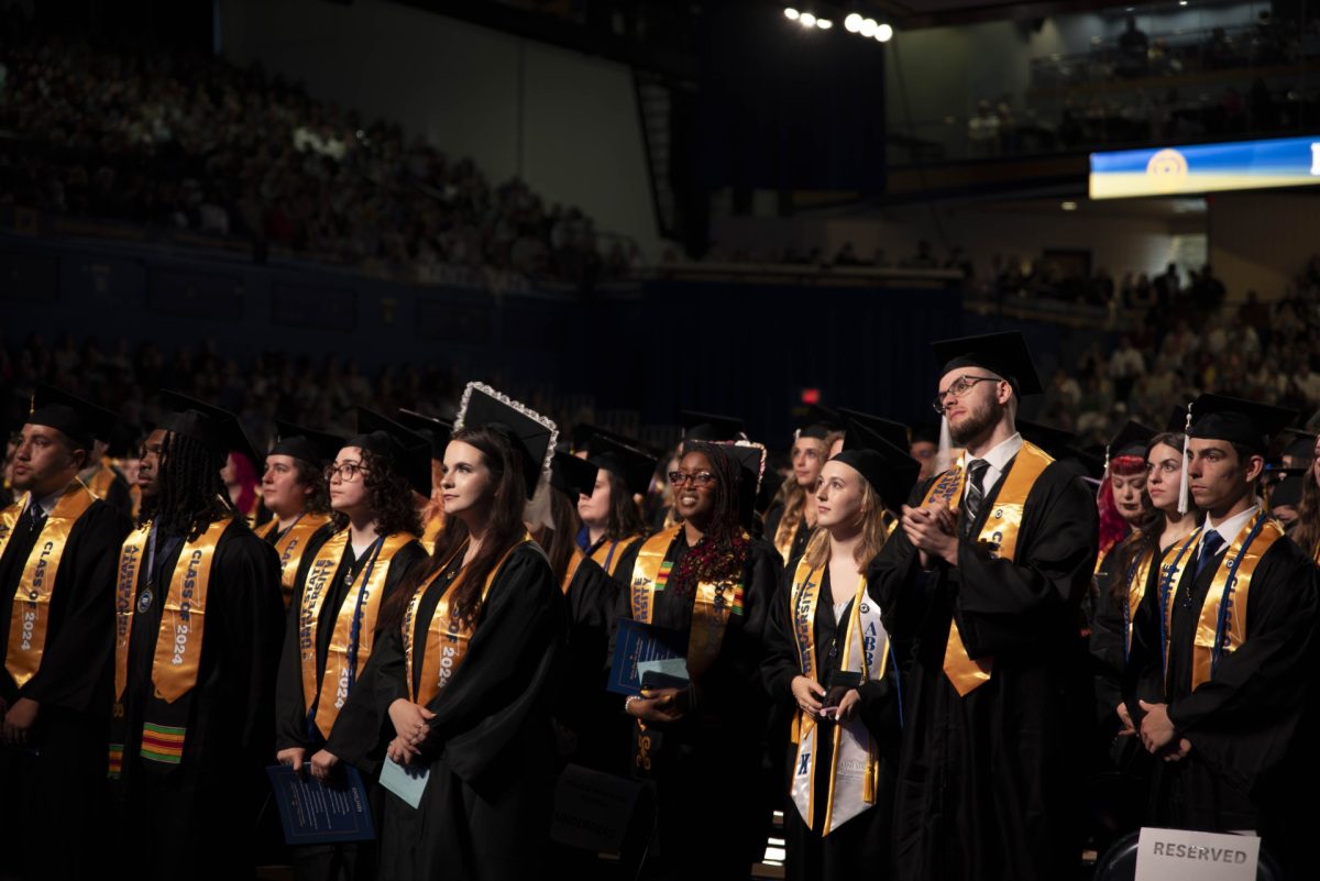 Graduates stand at commencement for the College of Arts and Sciences and the College of Communication and Information on May 10, 2024, in the Memorial Athletic and Convocation Center.