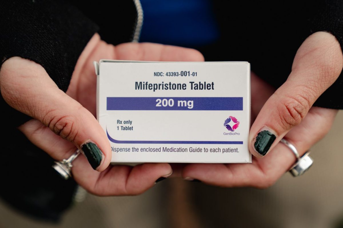 An abortion rights advocate shows a box of mifepristone outside the Supreme Court on March 26. Shuran Huang/The Washington Post/Getty Images