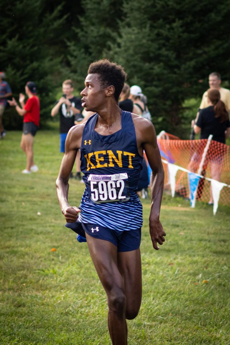 Baidy Ba casts a glance behind him right before he's about to finish first in the cross country meet Aug. 30, 2024.