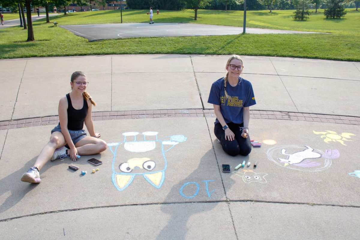 From left, seniors Madison Hawks and Maci Conrad draw the cartoon Bluey and a unicorn at the Chalk Competition on Aug. 26, 2024.