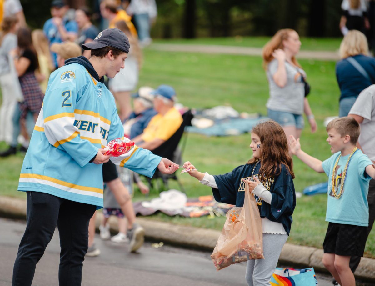 Kent State D1 Hockey player, JJ Creighton, hands out candy during the Homecoming parade, Sept. 28, 2024.