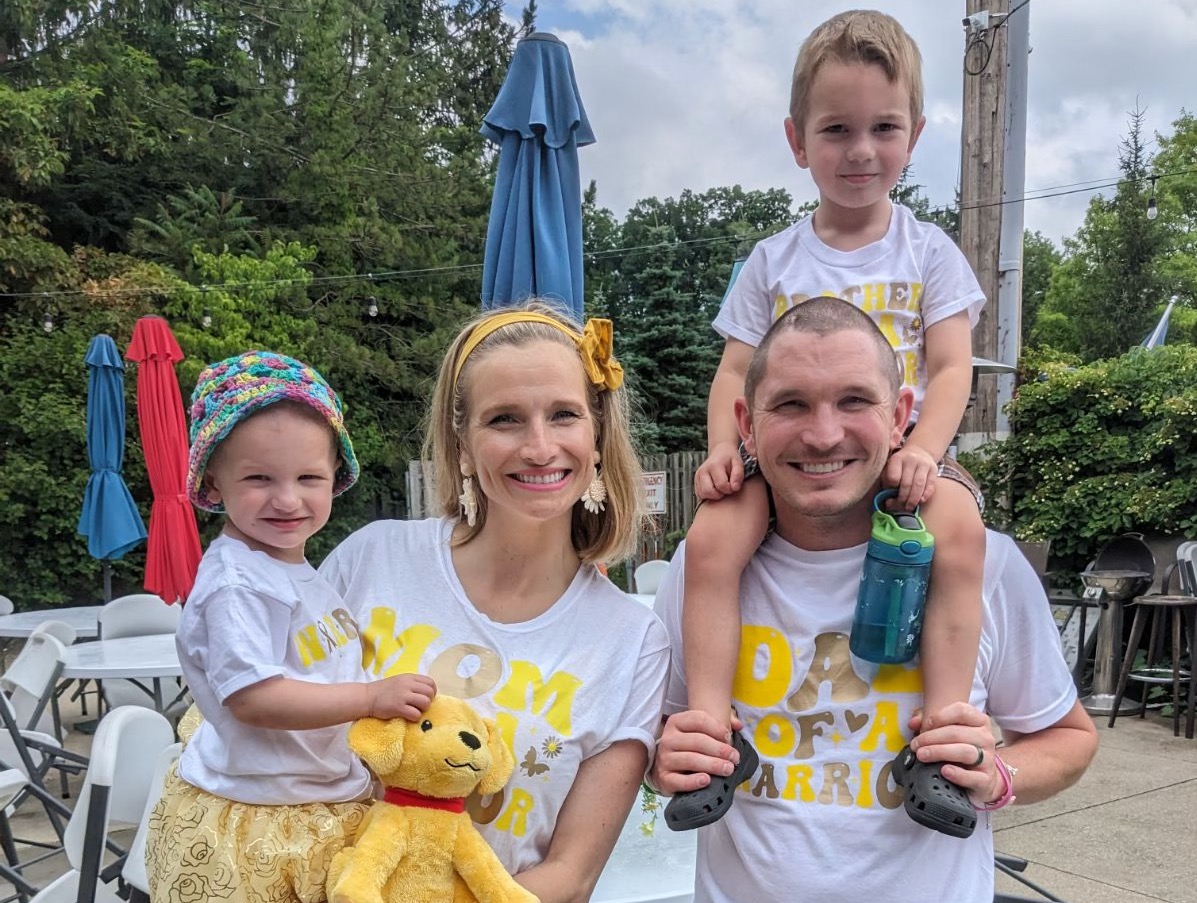 Meggi and Bryan Kranek pose with their children, McKenna and Clayton, at a fundraiser for McKenna this summer.