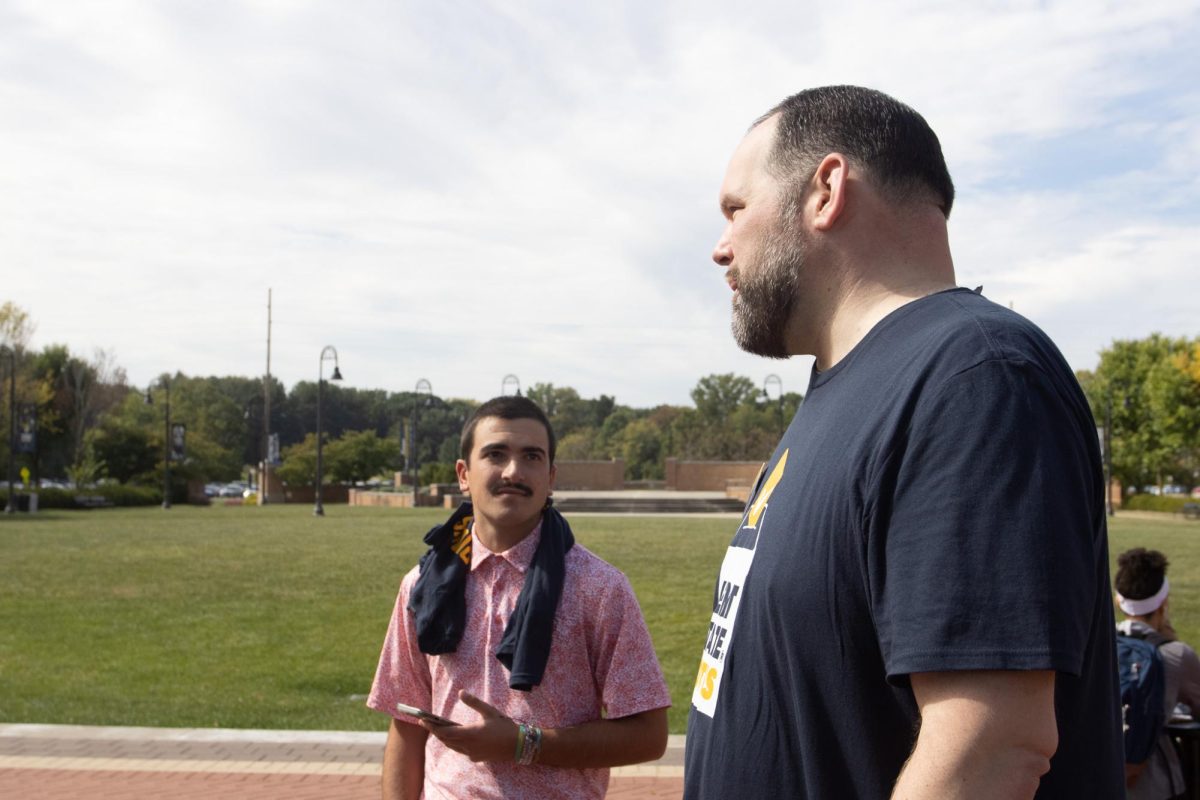 Co-Chair of the Kent State Votes Coalition Craig Berger talks with a student about the importance pledging to vote on Sept. 17, 2024.