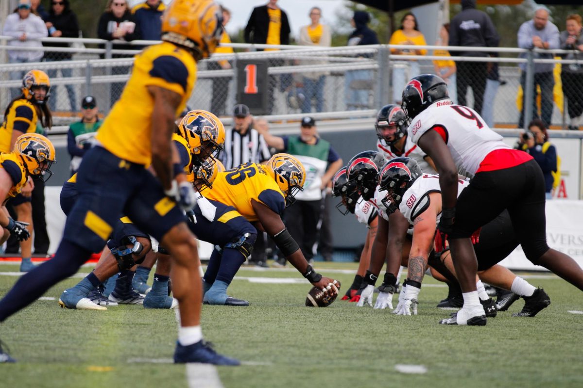 Kent State University's center, freshman Elijah Williams, get's ready to snap the ball to quarterback, junior Devin Kargman during the home opener against Saint Francis University on Sept. 7, 2024.  