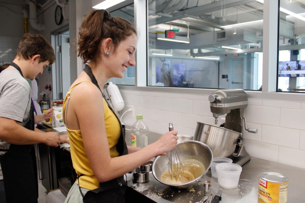 Senior Kaitlyn Graham stirs the dough for pumpkin crumb cake during a culinary class in the DI Hub on Sept. 13, 2024. 