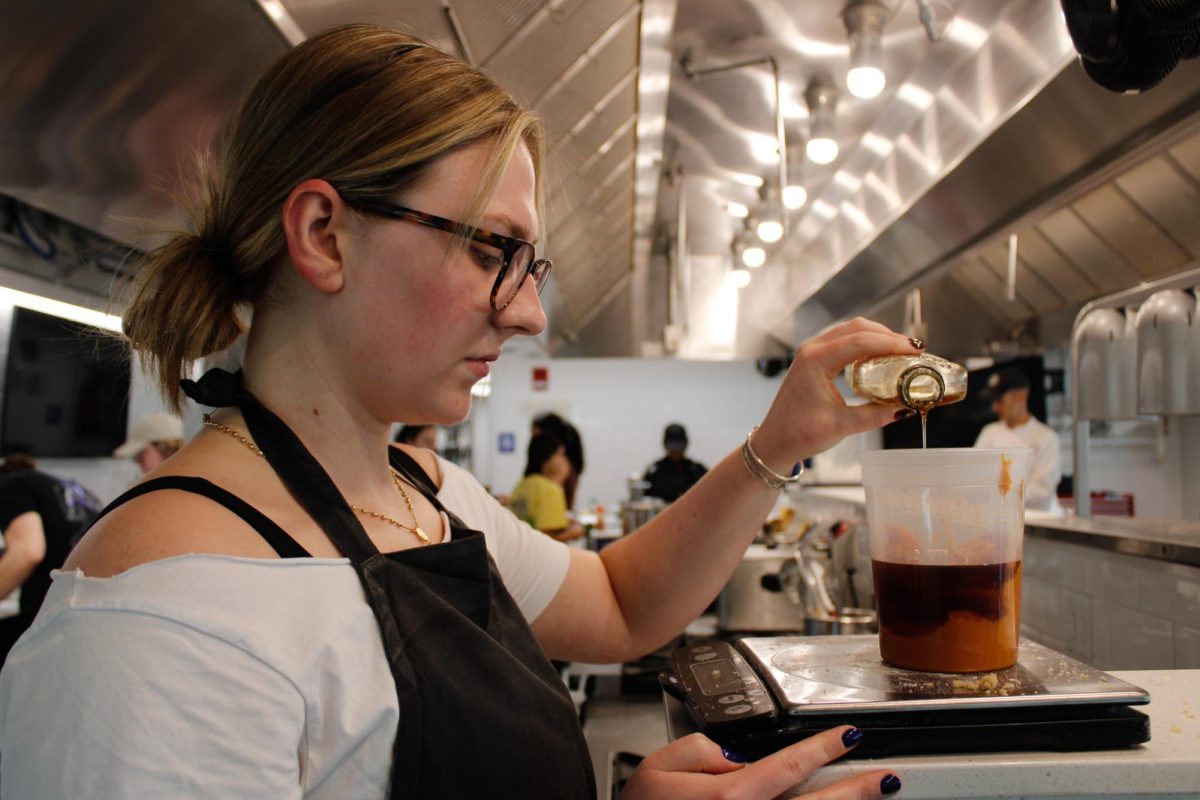 Senior, Sammy Wise pours maple syrup during a culinary class in the DI Hub on September 13, 2024. 