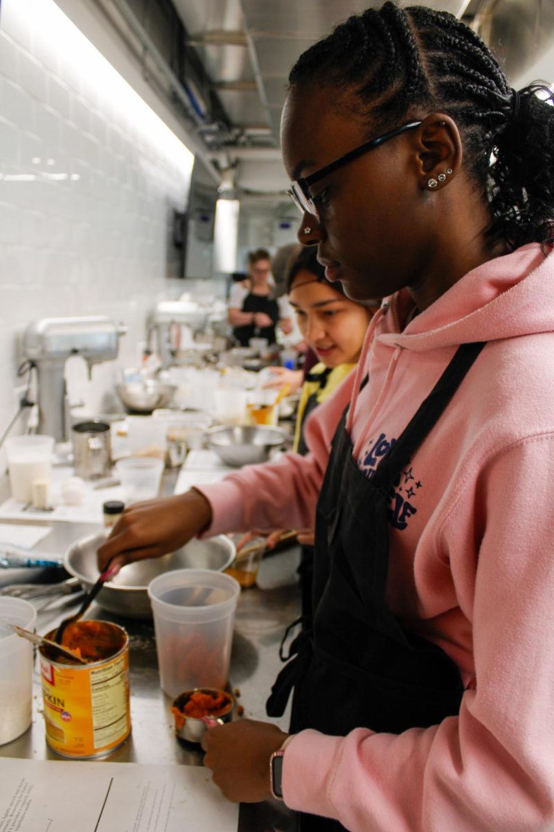 Sophomore, Trinity Davis and Senior, Alexa Valverde-Romero divide up the pumpkin for their recipe, pumpkin maple muffins, during a culinary class in the DI Hub on September 13, 2024. 