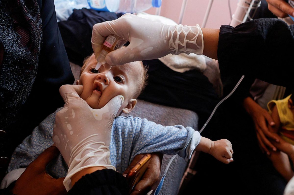 A Palestinian child is vaccinated against polio, amid the Israel-Hamas conflict, at Nasser hospital in Khan Younis in the southern Gaza Strip, August 31.